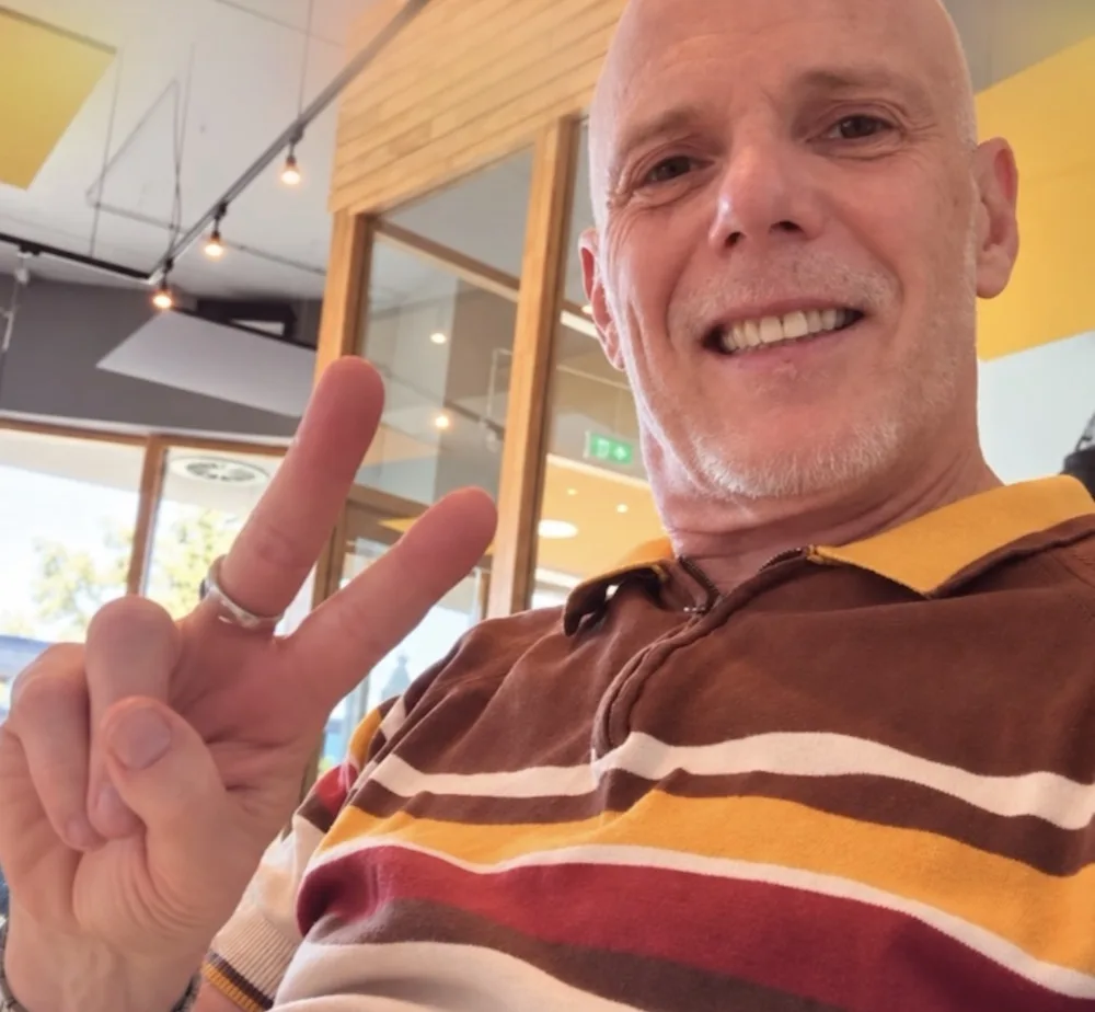Pieter Vijgeboom, maker van Walhalla, lacht en maakt een peace-teken